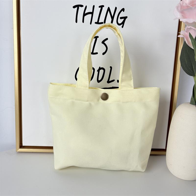 Effenkleurige eenvoudige lunchtas, draagbare canvas tas, kleine stoffen tas, draagbare canvas tas voor het opbergen van diverse spullen