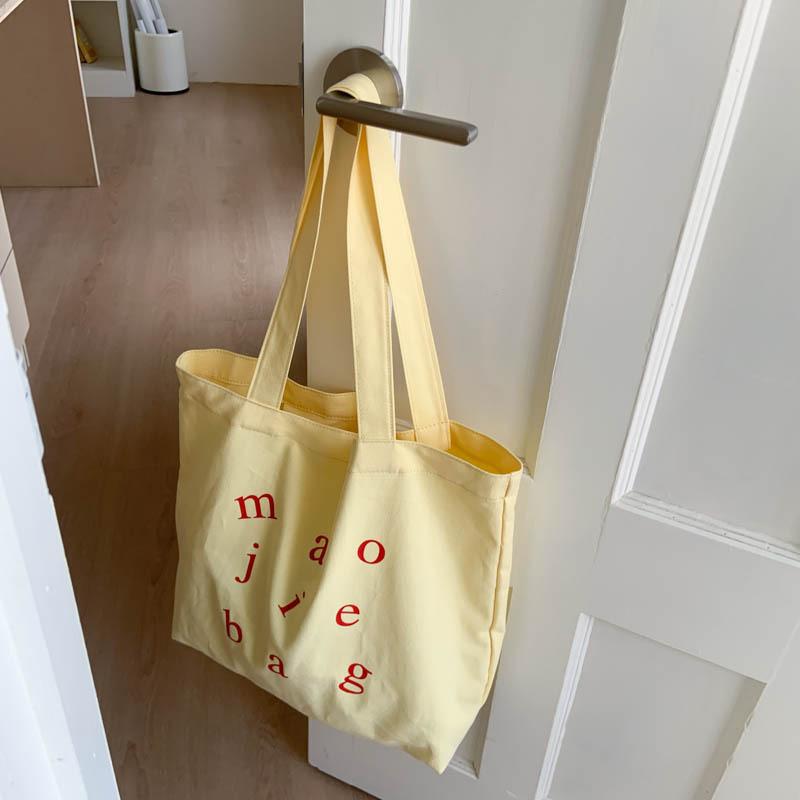 

Large capacity canvas bag women 2025 new lazy wind shoulder bag fashion letter tote bag simple commuter bag жовтий