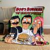 Cartoon characters gathered with a burger, some making humorous expressions. for all seasons blanket lunch break throw gift