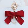 Elegant Pearl Strand Bow Keychain with Heart Charm, Octagonal Shape, Floating Fun-Themed Accessory, with Split Ring Closure for Handbags and Car Keys