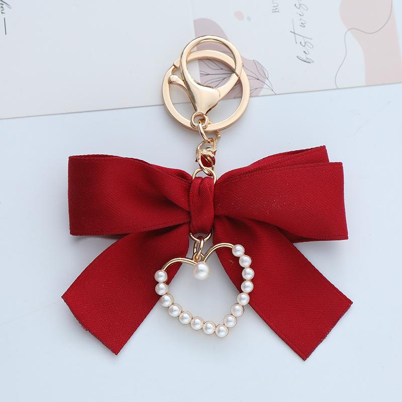 Elegant Pearl Strand Bow Keychain with Heart Charm, Octagonal Shape, Floating Fun-Themed Accessory, with Split Ring Closure for Handbags and Car Keys