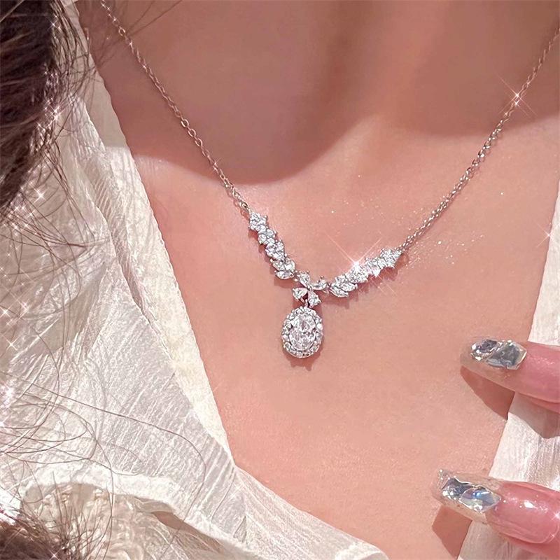 Women s Angel Wings Necklace: Luxurious Gemstone Sparkle, Retro Collarbone Chain with Pigeon Egg Style.