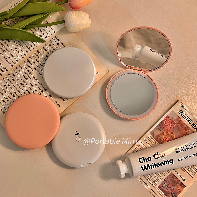 Portable LED Light Makeup Mirror - Compact, Handheld, Foldable, Round Mirror with Touch Light for Carry.