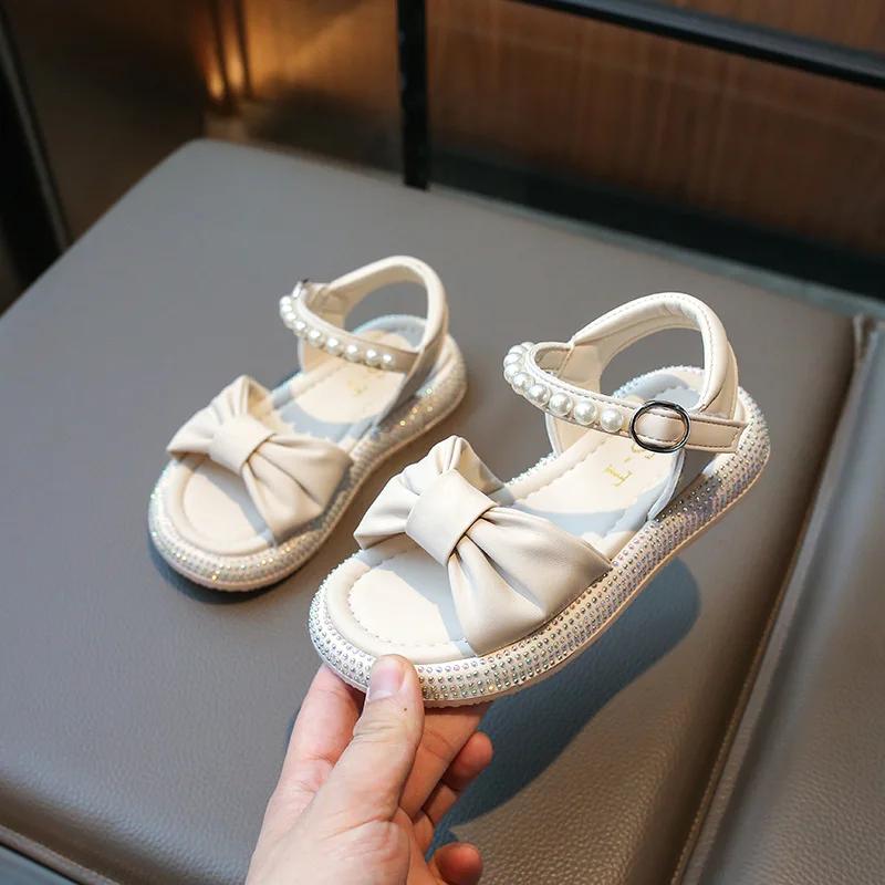 

2025 Summer New Children s Sandals Girls Summer Sandals Princess Bowtie with Crown Rhinestone Kids Flat Beach Shoes Open Toes 30 бежевый