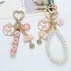 Cherry Blossom Rabbit Keychain with Pearl Chain and Woven Ribbon - Earphone Case and Bag Decoration with Folding Fan Design