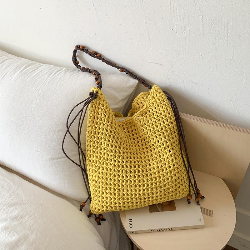 

Hollow woven fashionable large-capacity bucket bag women s summer new holiday wind beach straw shoulder bag жёлтый