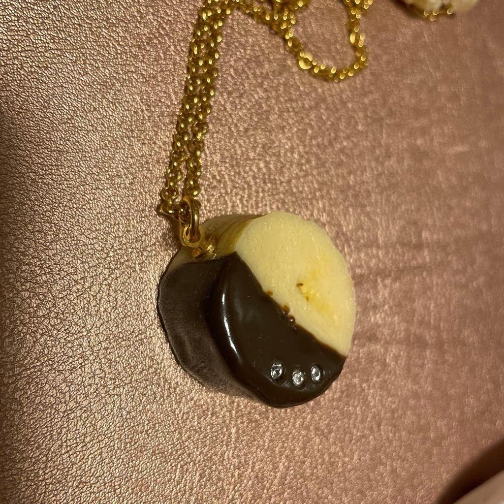 Used Q-POt banana chocolate necklace