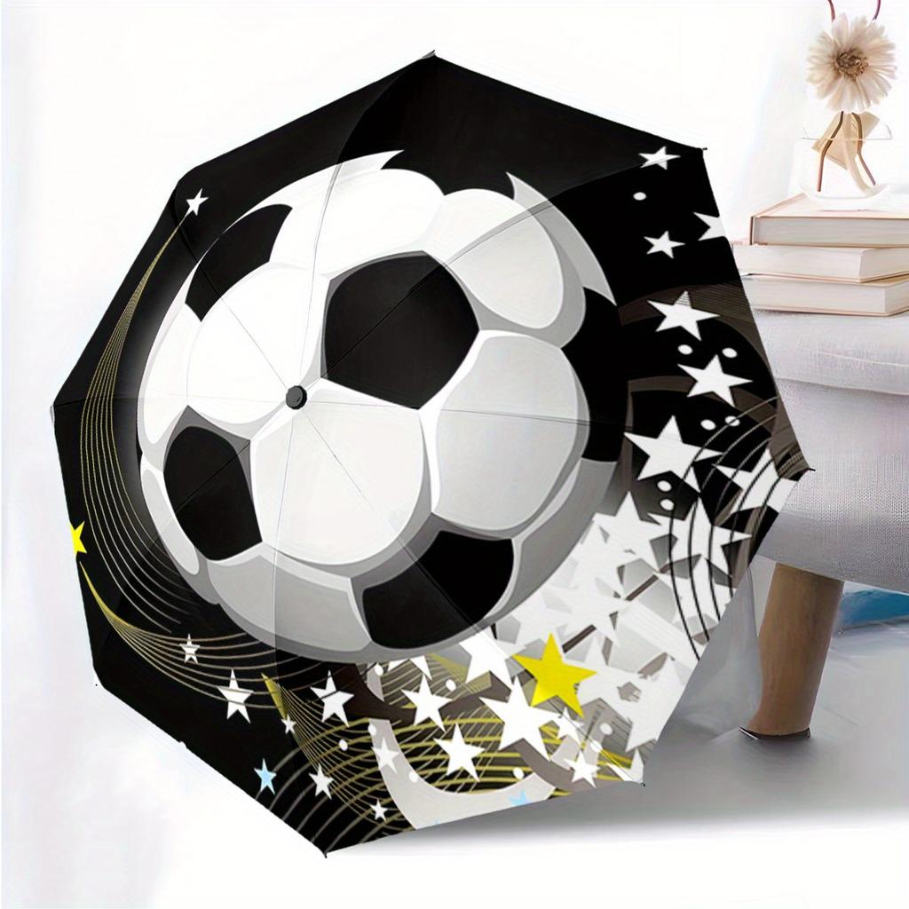 Folding Umbrella The umbrella features a soccer ball as the main design, with star patterns and curved yellow streaks. Fits Tr