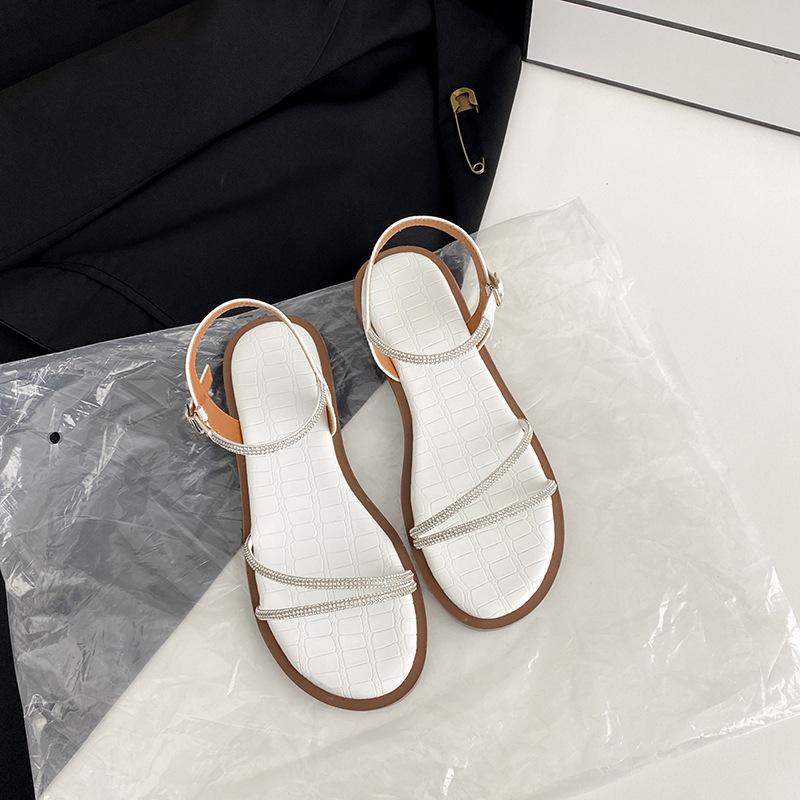 

Модные хрустальные сандалии на плоской подошве с узким ремешком женские повседневные дизайн с каменным узором женские сандалии лето 2025 студенческие плоские летние туфли 35 белый