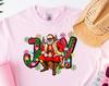 Brown Santa Joy Unisex Shirt and Kids Tshirt, Brown Santa, Unisex Shirt and Kids Tshirt, Grinch Era, Christmas, Trending Christmas, Pink Christmas