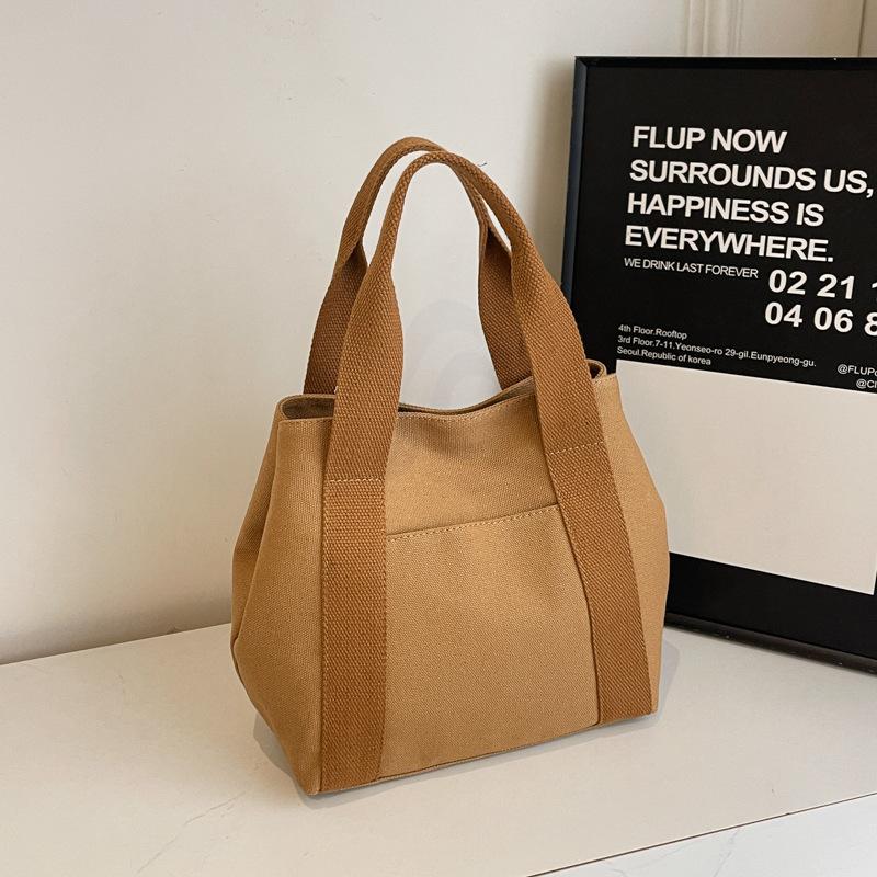 Large capacity 2025 tote bag Go to work Go out niche design Commuter simple literature Student clothing Handheld cloth bag