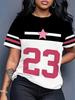 A Trendy Short-Sleeve T-Shirt Featuring a Color-Block Design In Black. White. And Pink. Adorned with a '23' Print And Contrasting Stripes On The Colla