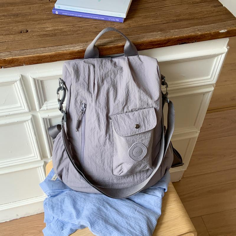 

Large capacity backpack simple women s new fashion messenger bag casual fabric men s shoulder backpack серый