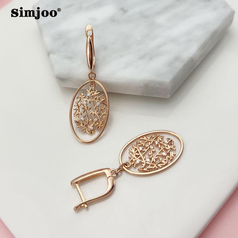 SIMJOO Różowe złoto Stylowe cyrkoniowe kolczyki z minimalnymi dzwoneczkami