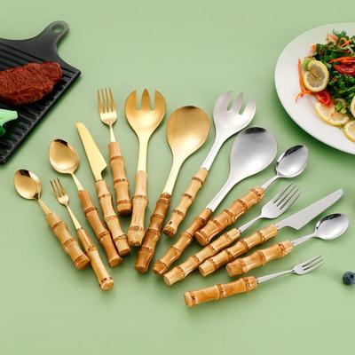 Bamboo-Handled Stainless Steel Cutlery Set: Dessert Fork, Steak Knife, Salad Spoon, Teaspoon.