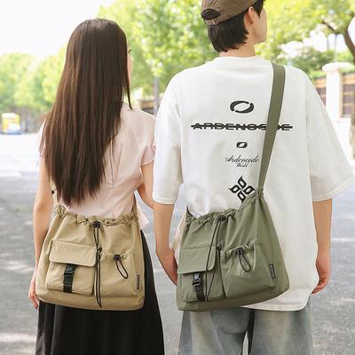 Koreaanse versie van kleine frisse trekkoord emmer tas vrouwelijke effen kleur textuur nylon stof boodschappen kleine schoudertas schattige schouder crossbody tas