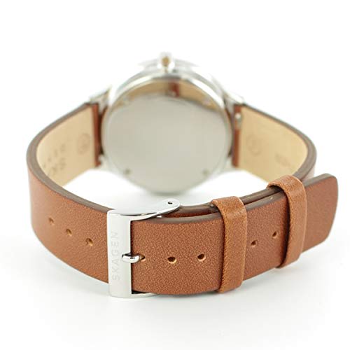 Skagen SKW6522, a simple, slim, Nordic-inspired watch by Grenen, with a silver dial and brown leather strap.