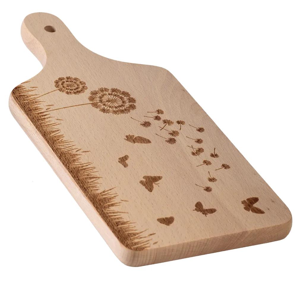Wooden cutting board with an engraved meadow