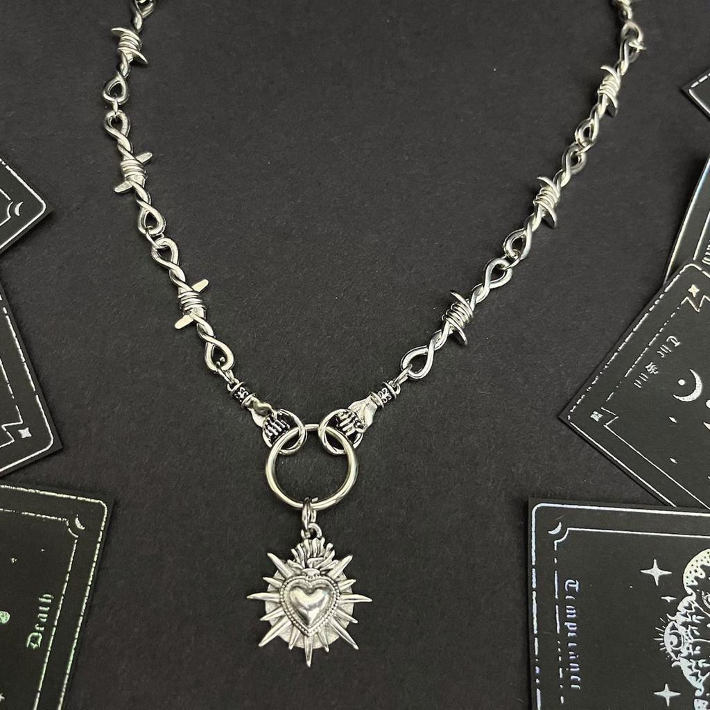 Unique Heart In Hand Barbed Wire Necklace Accessory Symbolizing Resilience and Tenderness for Fashion Enthusiasts