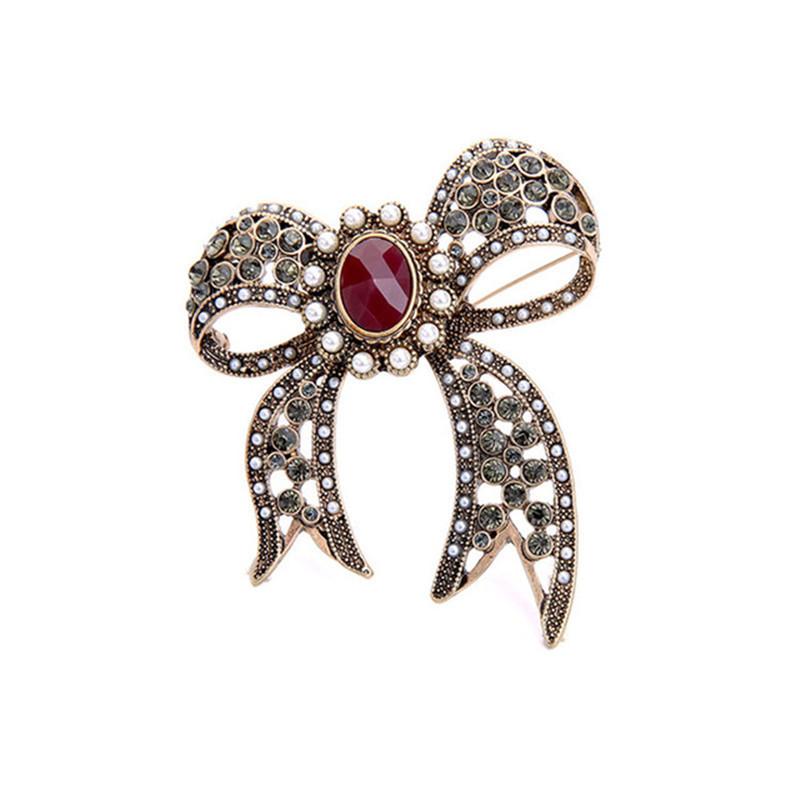 

Модный тренд ювелирные изделия Галстук Древний полый жемчуг Драгоценный камень Бант Подвеска Дамы Брошь