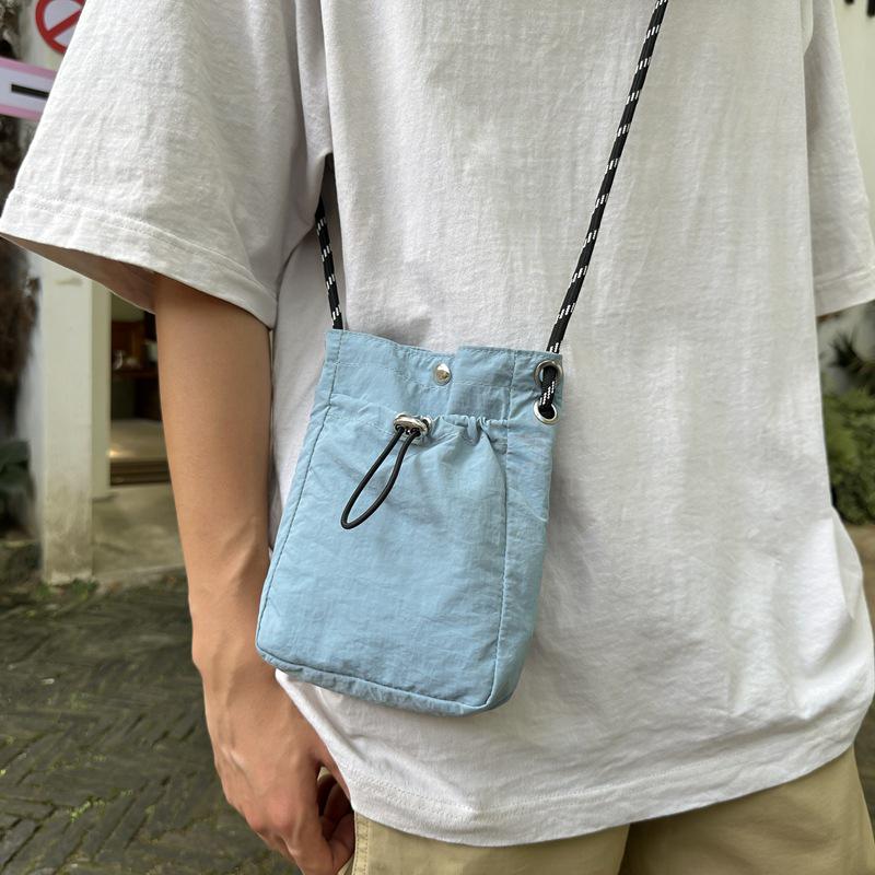 Stylish Crossbody Drawstring Bag: Trendy, Lightweight Cloth Phone Bag with Artistic Niche Design