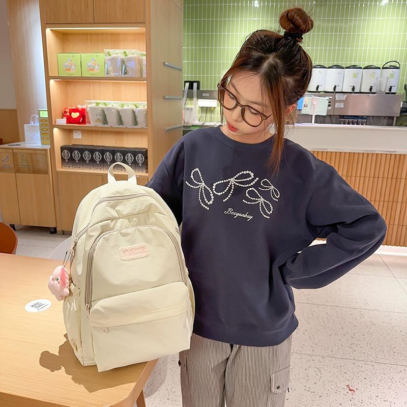Frühling Neu Nylon Leicht Niedlich Einfarbig Buchstaben Lässig Große Kapazität Rucksack für Mittelschüler