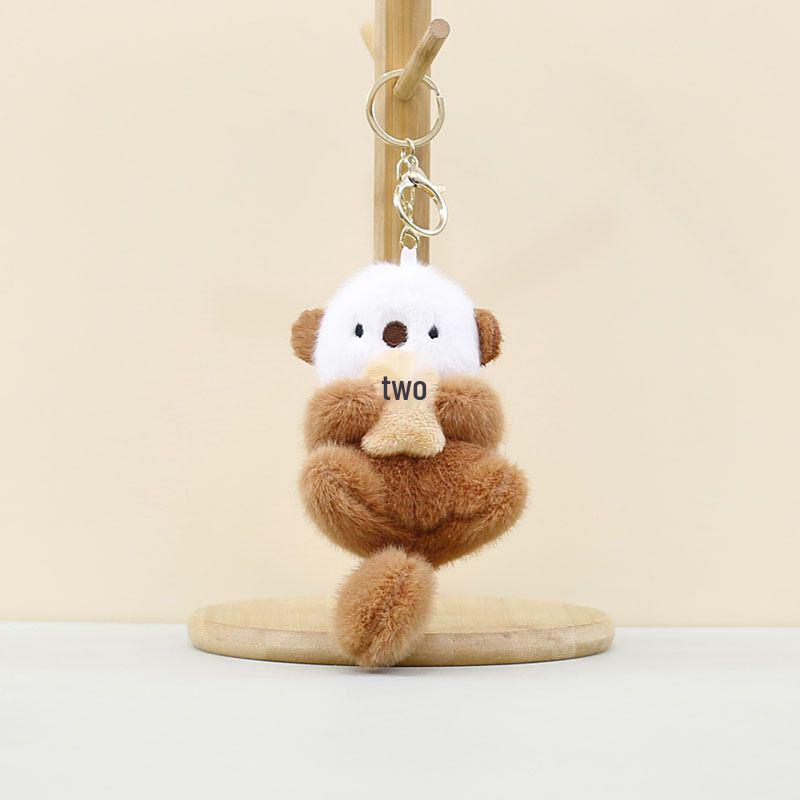 Cartoon Sea Otter Plush Keychain: Cute Fish-Hugging Sea Dog Pendant for Backpacks & More