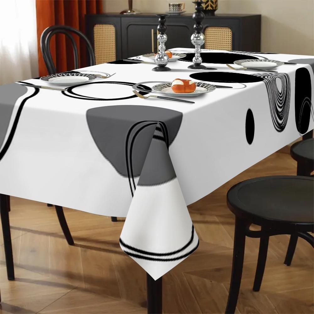 One modern minimalist tablecloth with bold black, white and gray geometric patterns, suitable for indoor and outdoor dining.PMJ