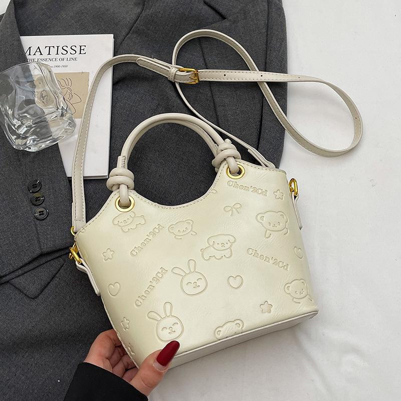 2025 new niche embossed fashion personalized portable bucket bag high-end commuter versatile women's messenger bag