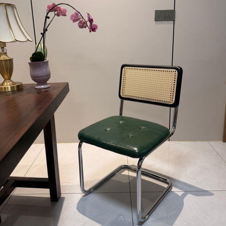 Elegantly crafted armless rattan dining chair in retro pastoral style, perfect for cafes, guesthouses, and vintage settings.