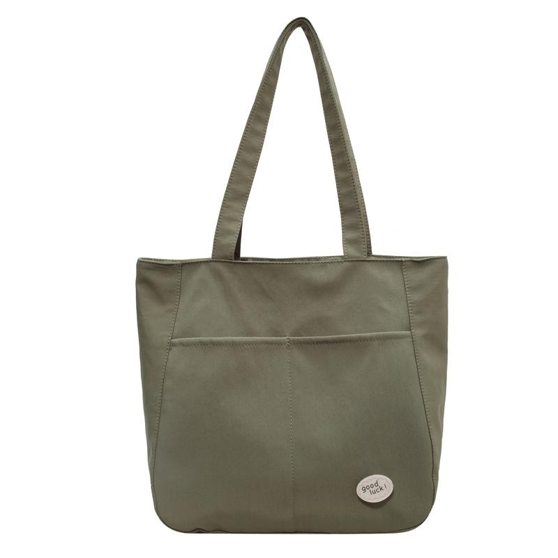 

Студенческая сумка для поездок 2025 новая нишевая сумка-мессенджер через плечо большой вместимости, легкая и простая однотонная сумка-тоут зелёный