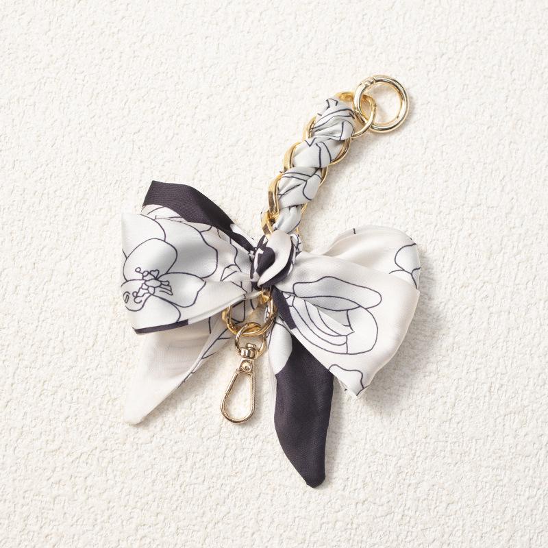 Elegant Hand-Woven Scarf Chain with Bow Decoration Pendant for Bag Strap Modification.