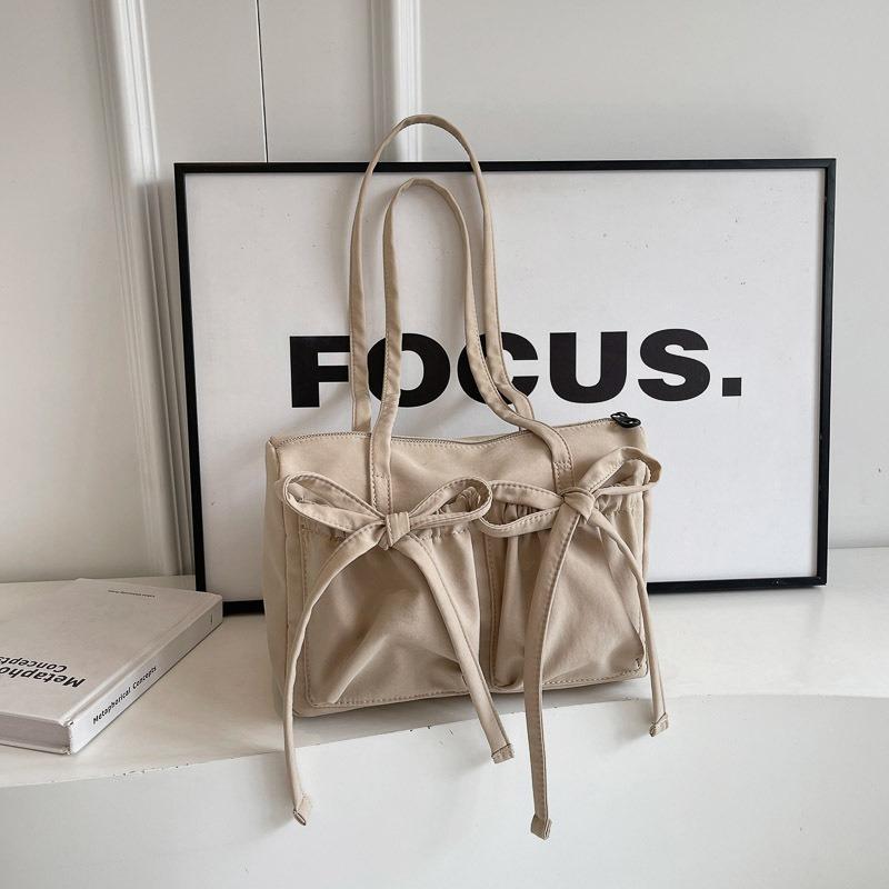 Nova bolsa tote com laço, senso de alta qualidade, bolsa de ombro de grande capacidade, bolsa axilar feminina simples de cor sólida para o dia a dia