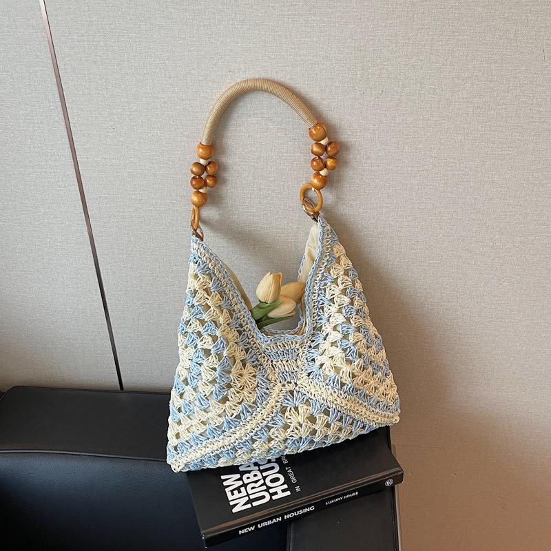 Sommer beliebte gewebte Tasche Damen neue Mode hohl tragbare Umhängetasche Strandurlaub Tragetasche