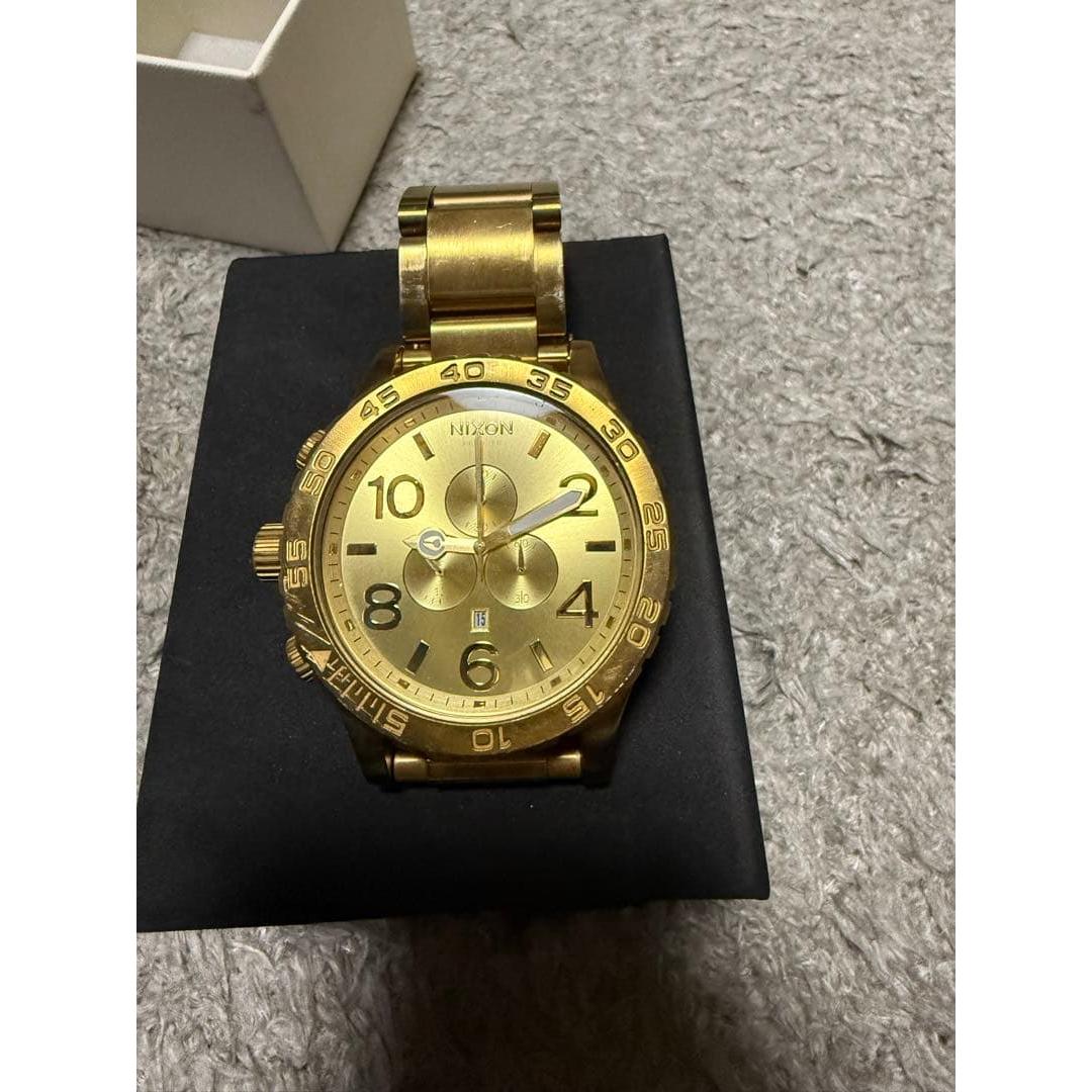 Used NIXON men s watch gold color