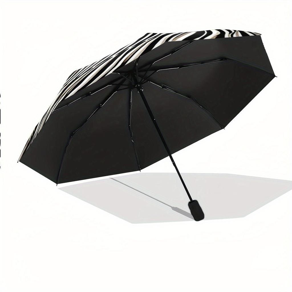 This Compact Umbrella Showcases a Striking Black And White Optical Illusion Design, Highlighted by a Large White Tiger in The