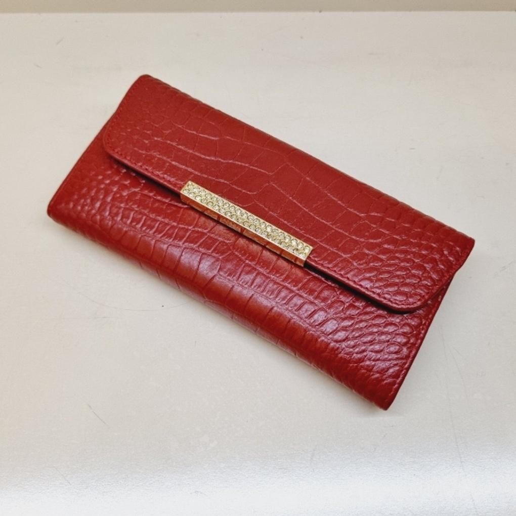 A soft, slim women's long wallet with a subtle pattern.