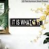 Metal Sign Featuring The Phrase 'IT IS WHAT IT IS' In A Rustic Style, Perfect for Vintage Wall Art In Your for Home, Garage, or Man Cave. This
