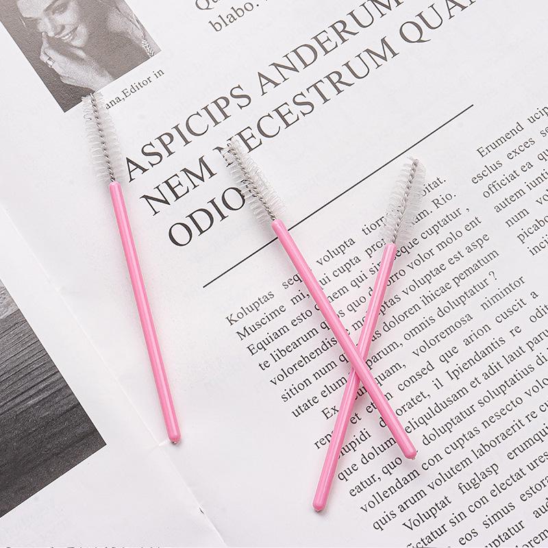 50-Pack Disposable Eyelash Brushes - Portable Pink-Handled Makeup Tool for Eyebrow and Eyelash Application.