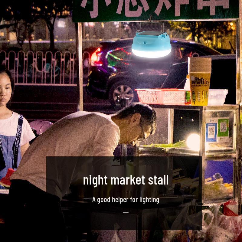 Portable Super Bright LED Solar Camping Light with Long Battery Life for Outdoor and Night Market Use.