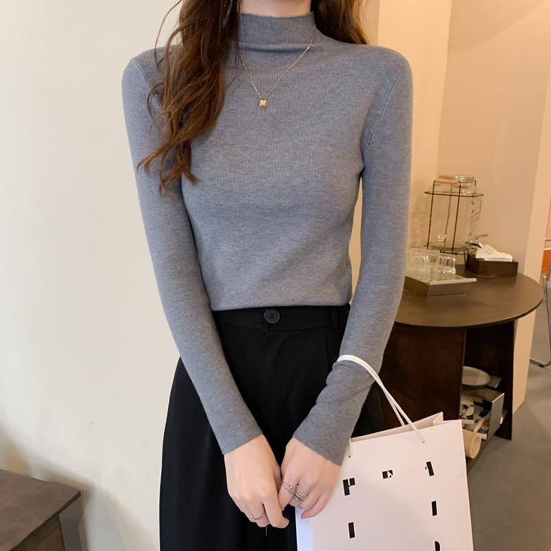 Nuevo invierno ajustado tejido de punto Color sólido cuello redondo señoras moda camisa por el trasero suéter mujer ropa
