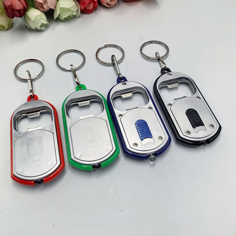 Ouvre-bouteille LED Multifonctionnel Mini Lampe de Poche Illuminée Porte-clés Pendentif