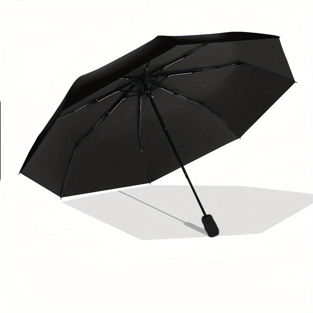 A Compact Folding Umbrella Featuring an Angry Cartoon Face. It'S a Convenient Outdoor Accessory Suitable for Any Season, Making It a Great G
