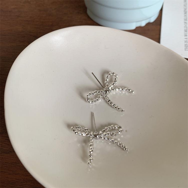 Elegant Silver Bow Ear Studs: Luxury S925 Silver Needle Earrings for Women.