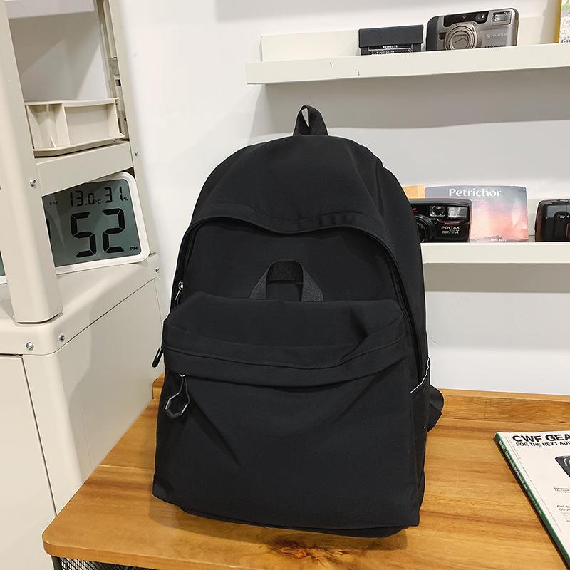 Casual large-capacity backpack fashionable outdoor lightweight junior high school students solid color simple schoolbag Korean version travel backpack