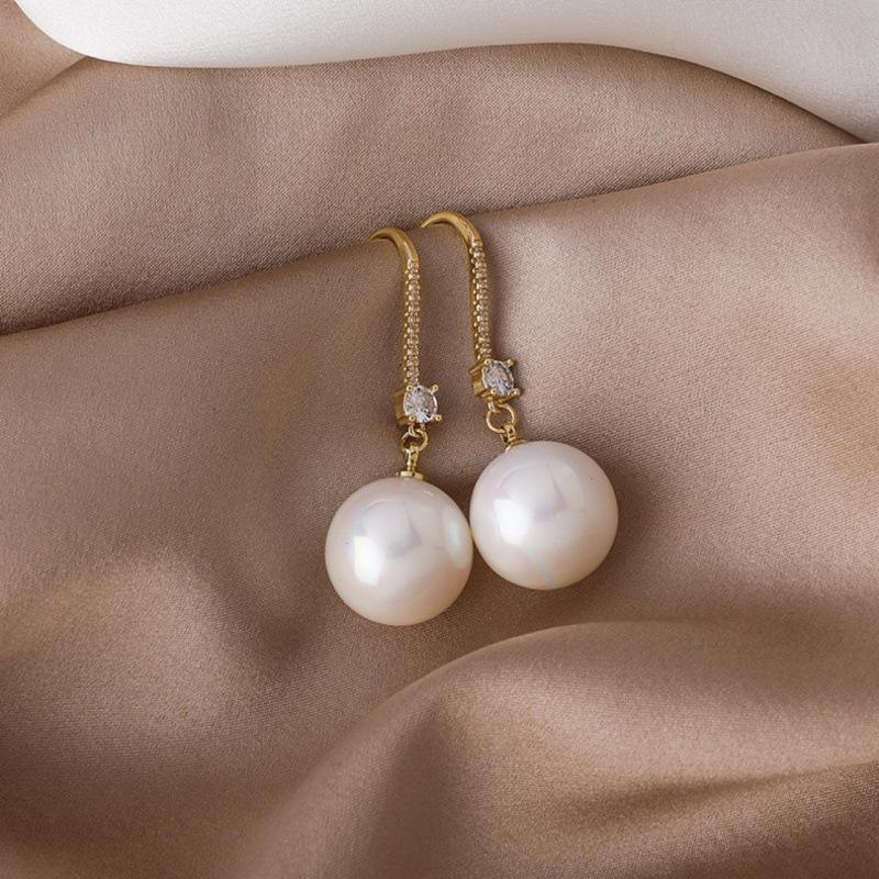 

Light luxury temperament high sense New Year s red pearl earrings women, cold style versatile fashion ear hook Internet celebrity earrings