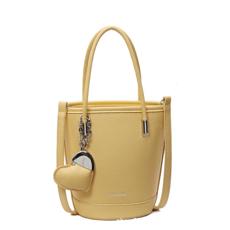 New niche simple solid color lychee pattern texture hand carrying bucket bag versatile foreign style commuting messenger women's bag