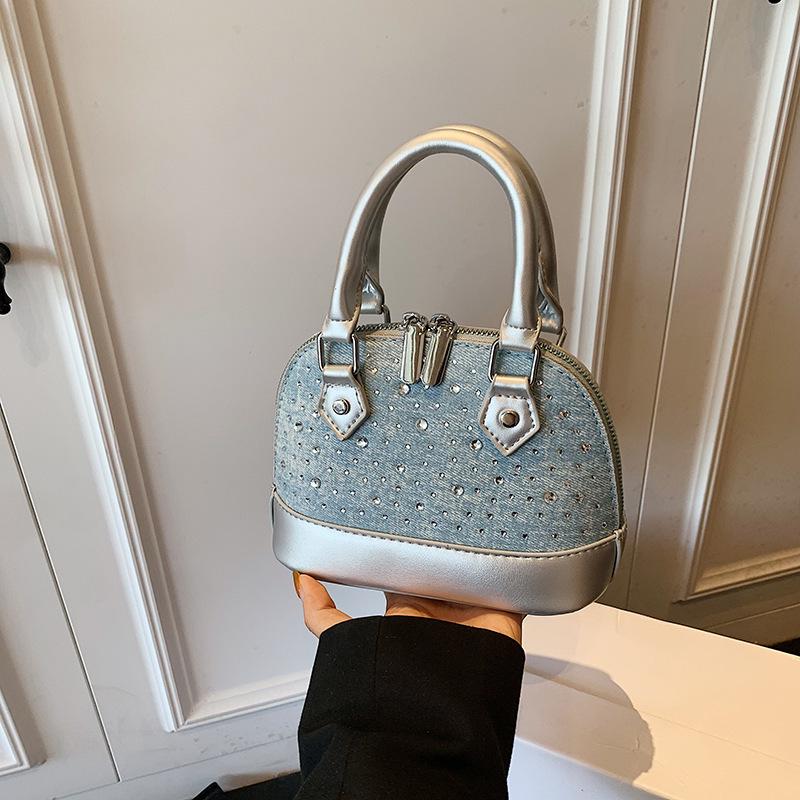 

New niche design high-end versatile rivets portable fashionable single shoulder oblique span shell bag серебряный