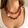 Stylish Red Resin Irregular Bead Necklace With Adjustable Length For Personalized Fit And Artistic Design In Sturdy Alloy Construction.
