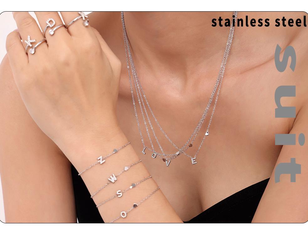 Oumeika Titanium Steel Jewelry Set: 26 Zircon-Inlaid Letters, PVD Gold-Plated Necklace, Bracelet, Earrings, and Ring.